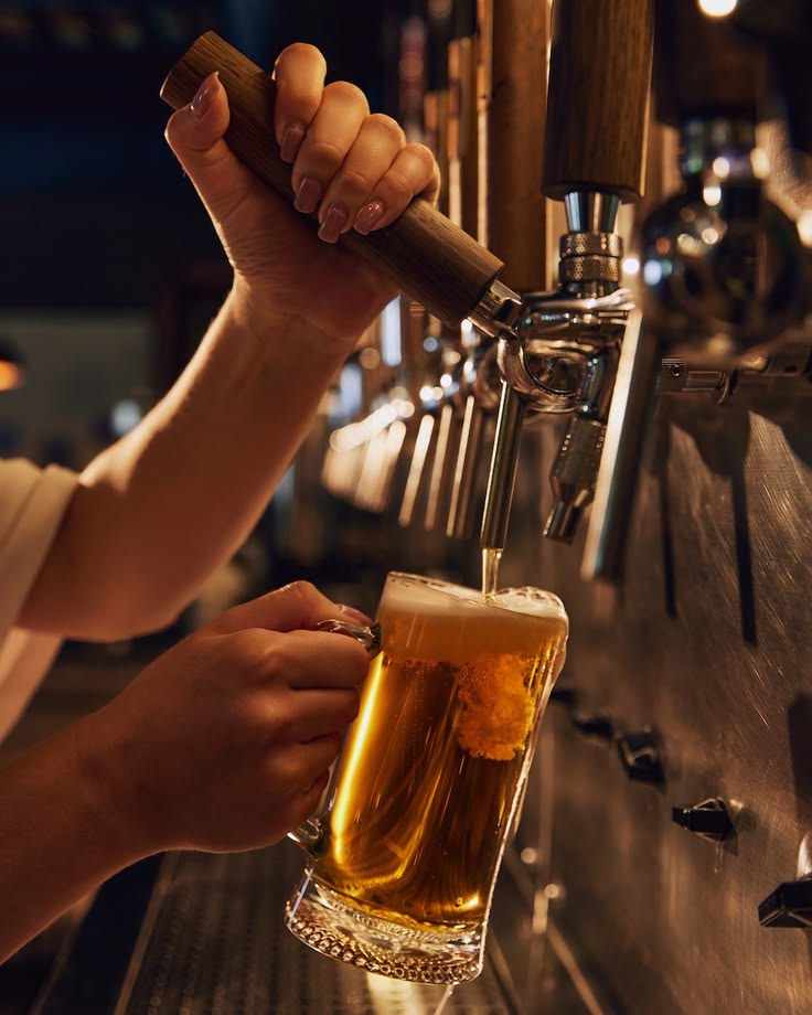 Frosty mug of beer being poured from the tap