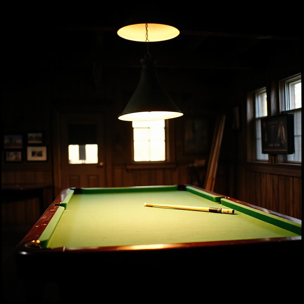 Vintage pool table under a hanging lamp